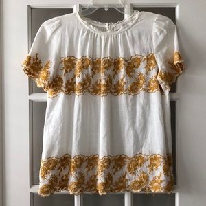 Linen top with gold appliqué.